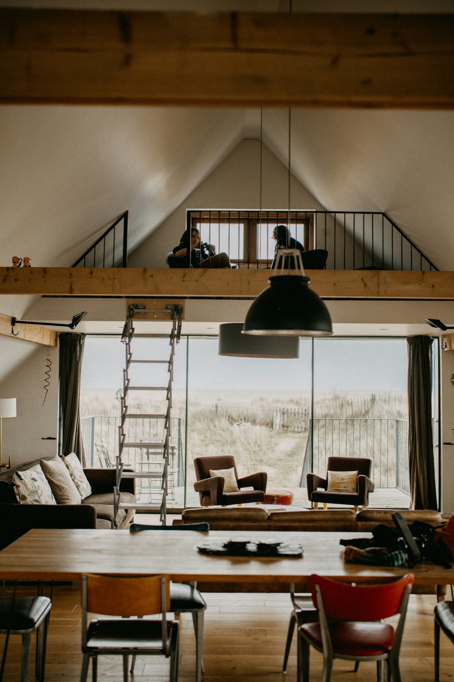 A well-kept coastal living space with a view of the dunes